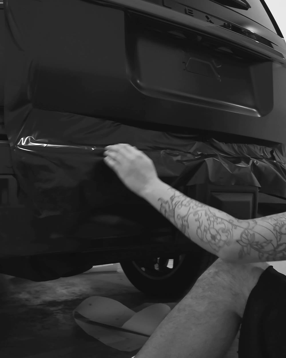 Installer trimming and tucking a film edge