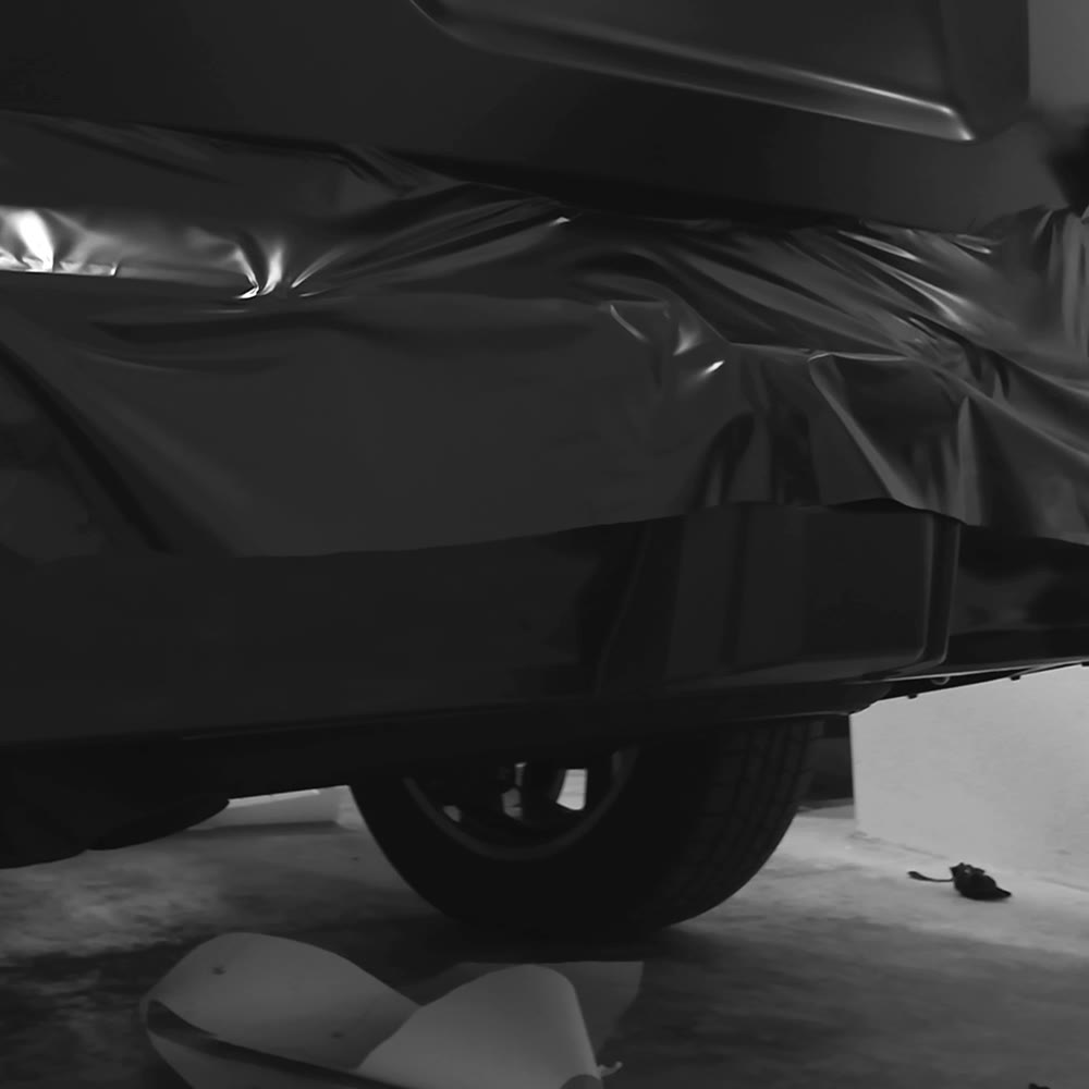 Wrap film laid over a rear bumper before forming